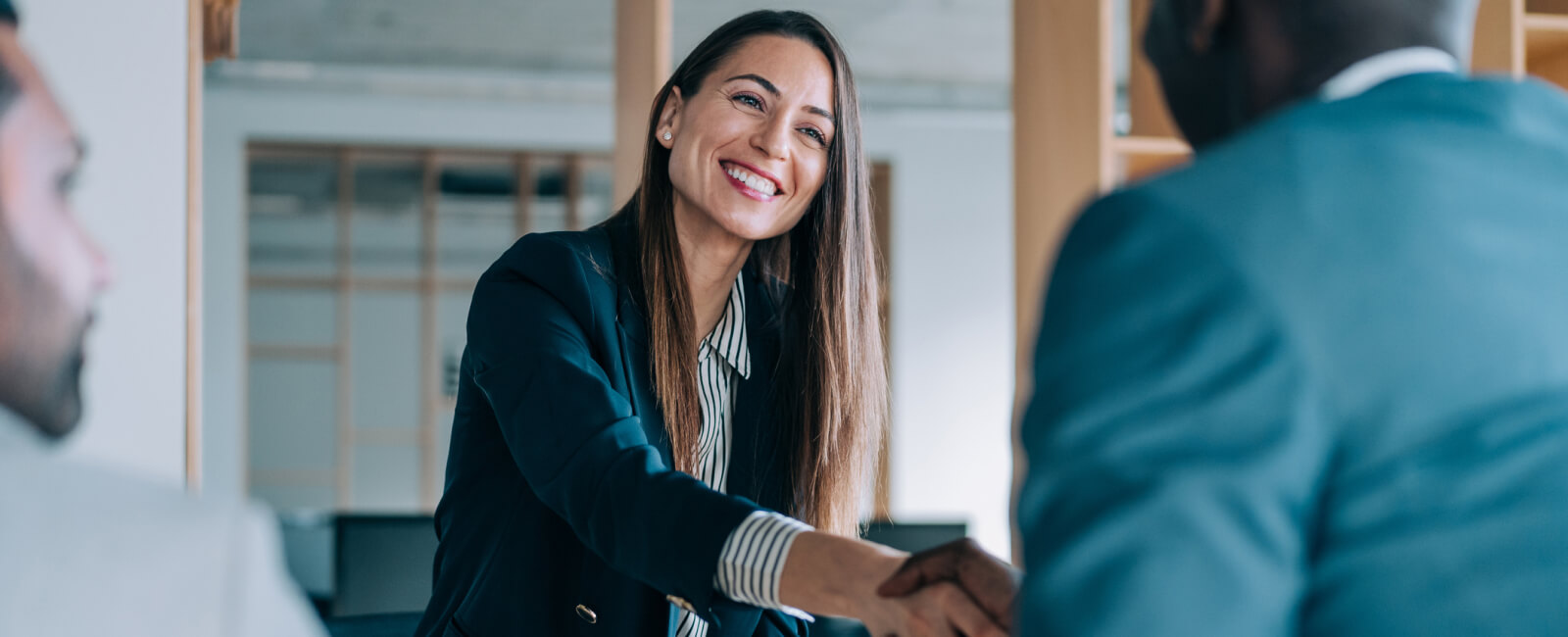 Photo of woman shaking hands with customers