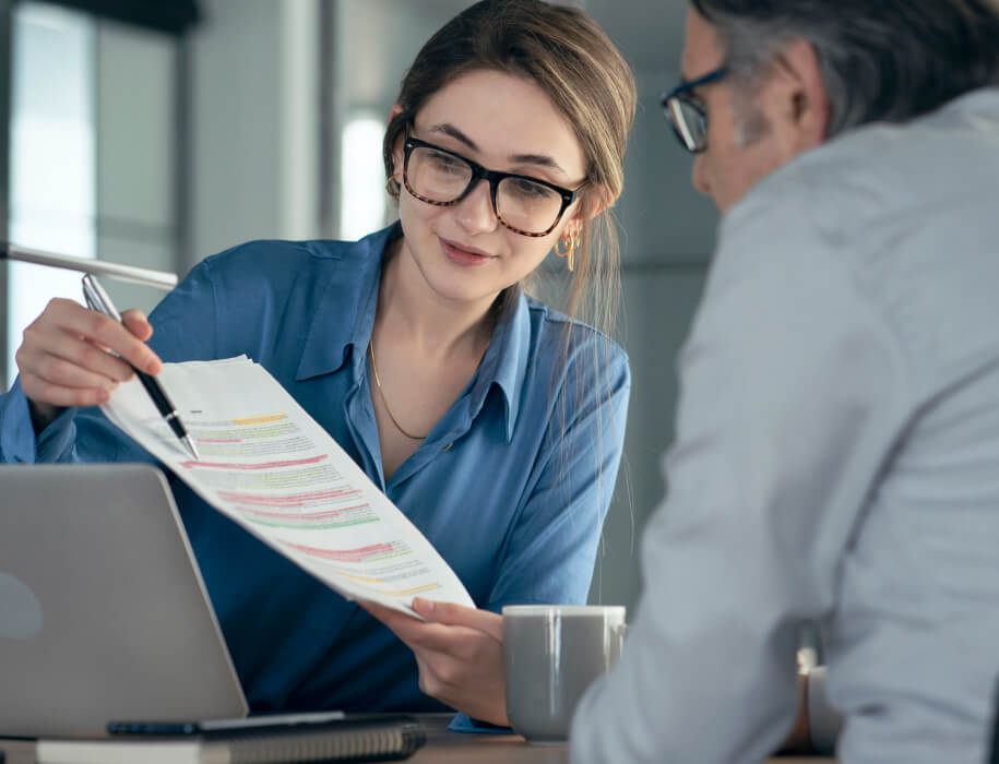 Woman showing a man a document with highlighted text