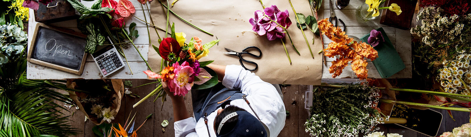 photo of florist making arrangements on table